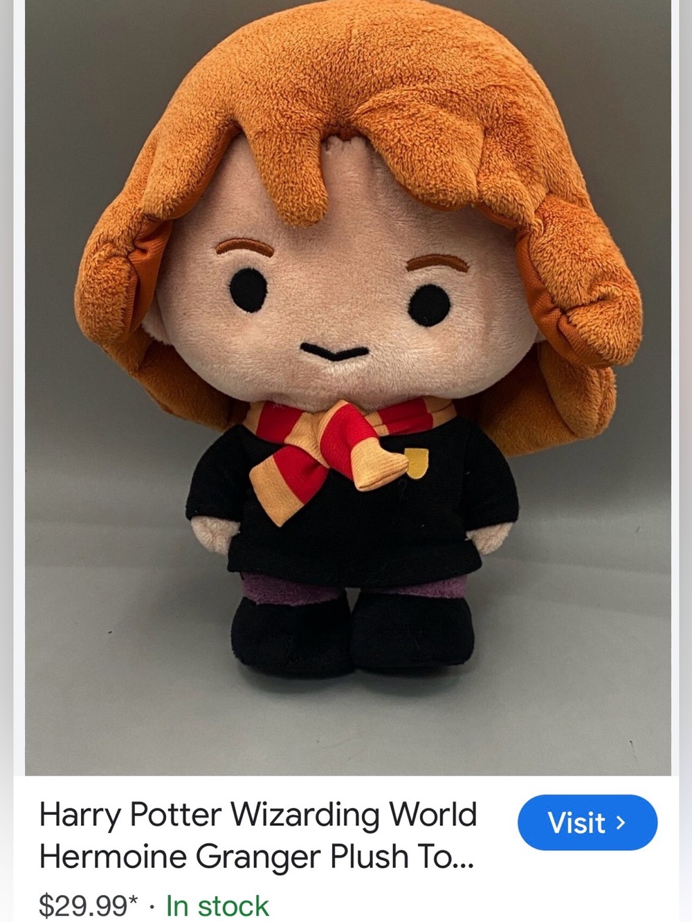 Wizarding World Hermione Granger plush doll with a red and gold striped scarf.
